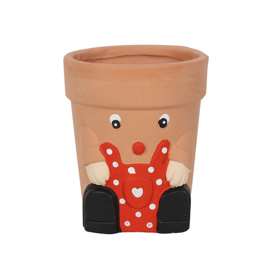  A fun small novelty plant pot in a brown terracotta with a red polka dot apron.