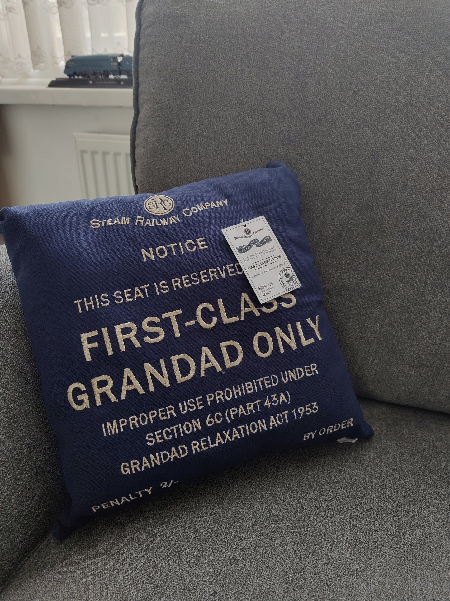 An image of a first class grandads only seat cushion in a blue square with embroidered text.