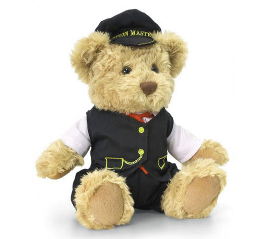 An image of a cute teddy bear called William, dressed as a railway station master with a hat and tie.