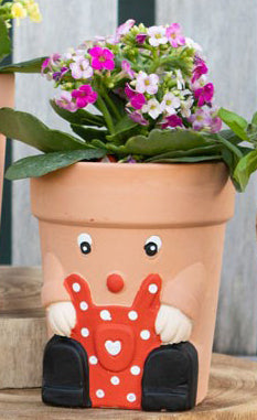 A novelty plant pot gift for gardeners, featuring cute eyes a red apron and little booties.