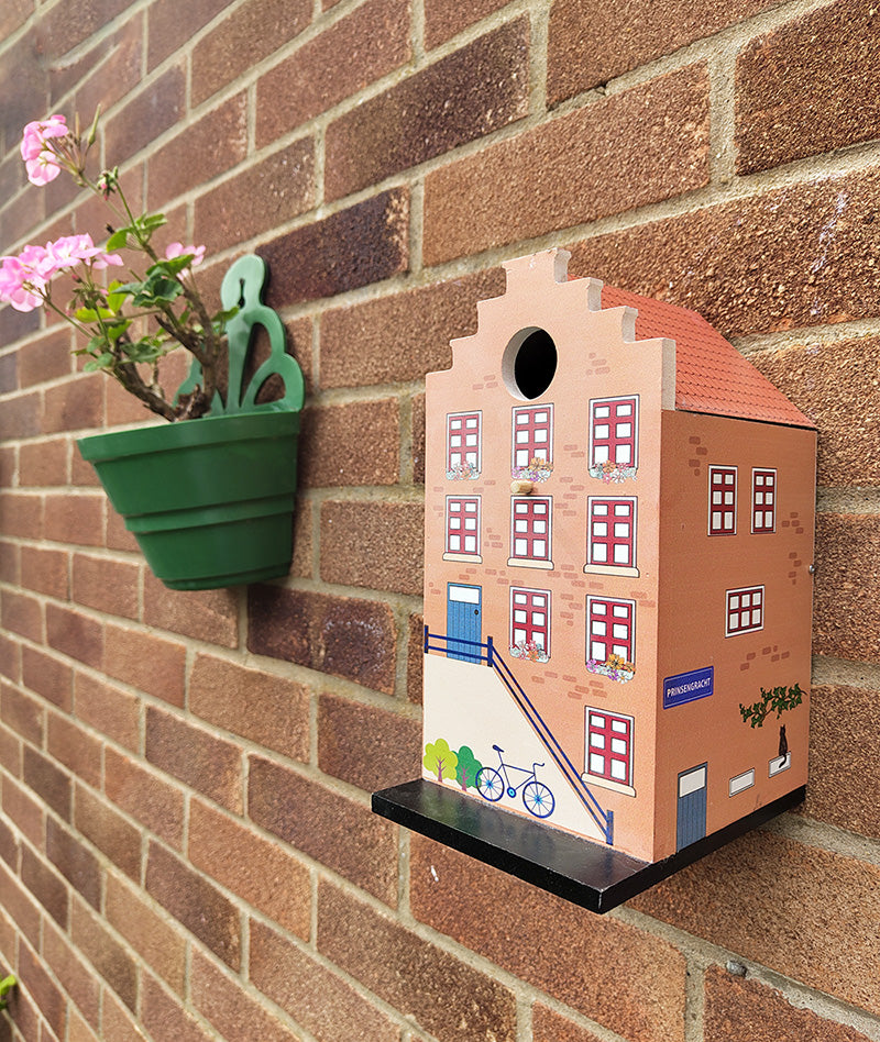 A cute garden birdhouse for bluetits and small birds.